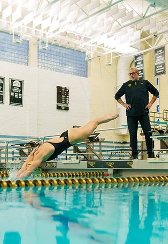 Coach teaching swimmer